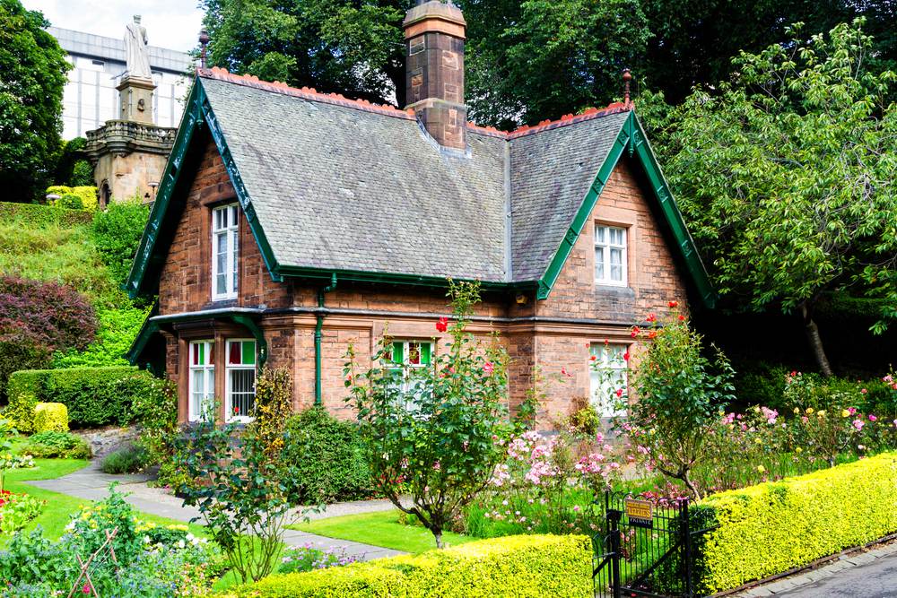 cottage with lots of planting around it 