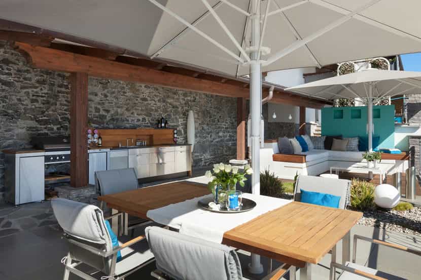 outdoor kitchen area with tables and chairs