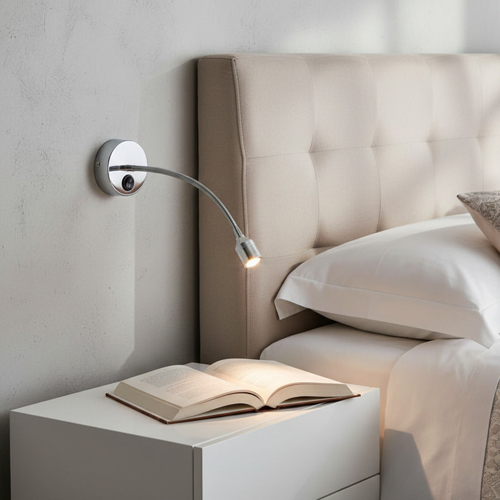 silver flexible reading lamp mounted on the wall next to a bed