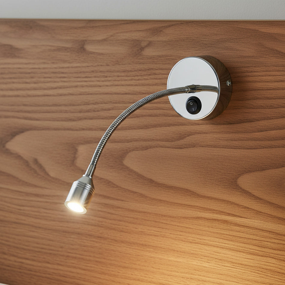 polished chrome flexible reading light mounted on a wood headboard
