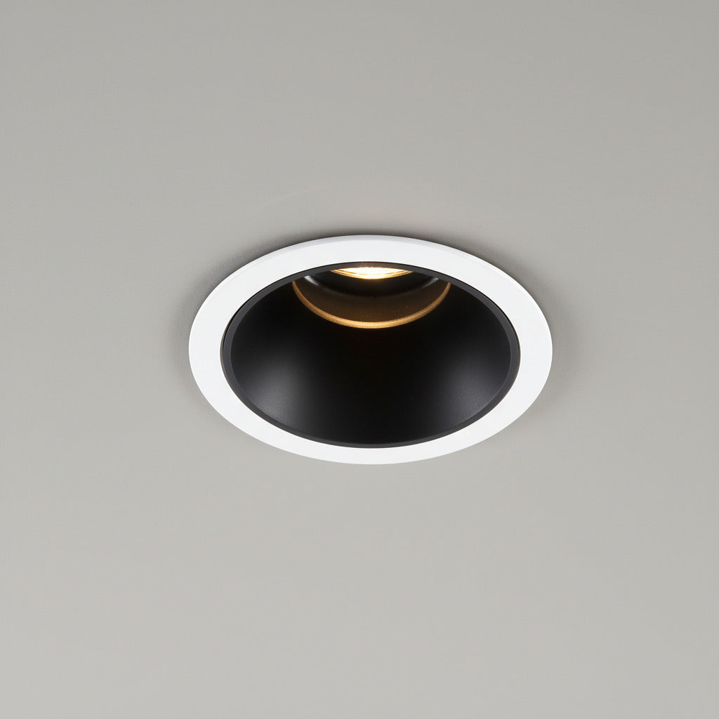 black recessed downlight installed on a grey ceiling 