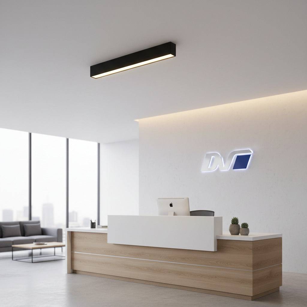 black linear surface downlight mounted over an office reception desk 