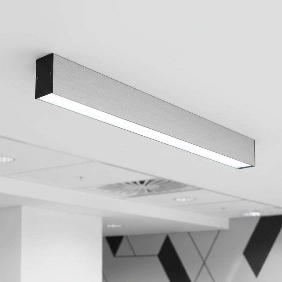 silver slim surface mounted downlight mounted on an office ceiling