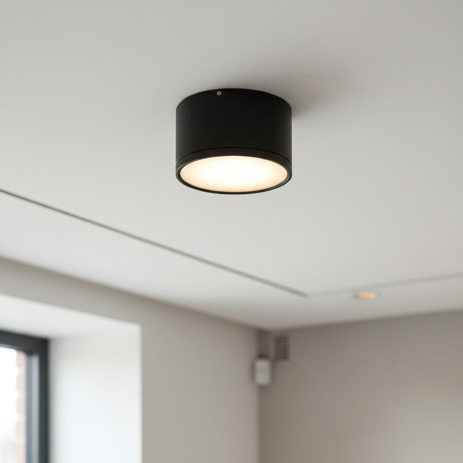 black round LED surface mount light shown on the ceiling in a house