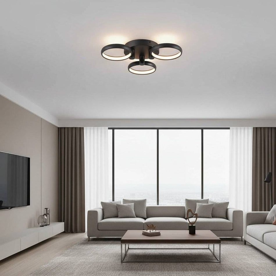 black flush ceiling light mounted on the ceiling of a modern apartment room