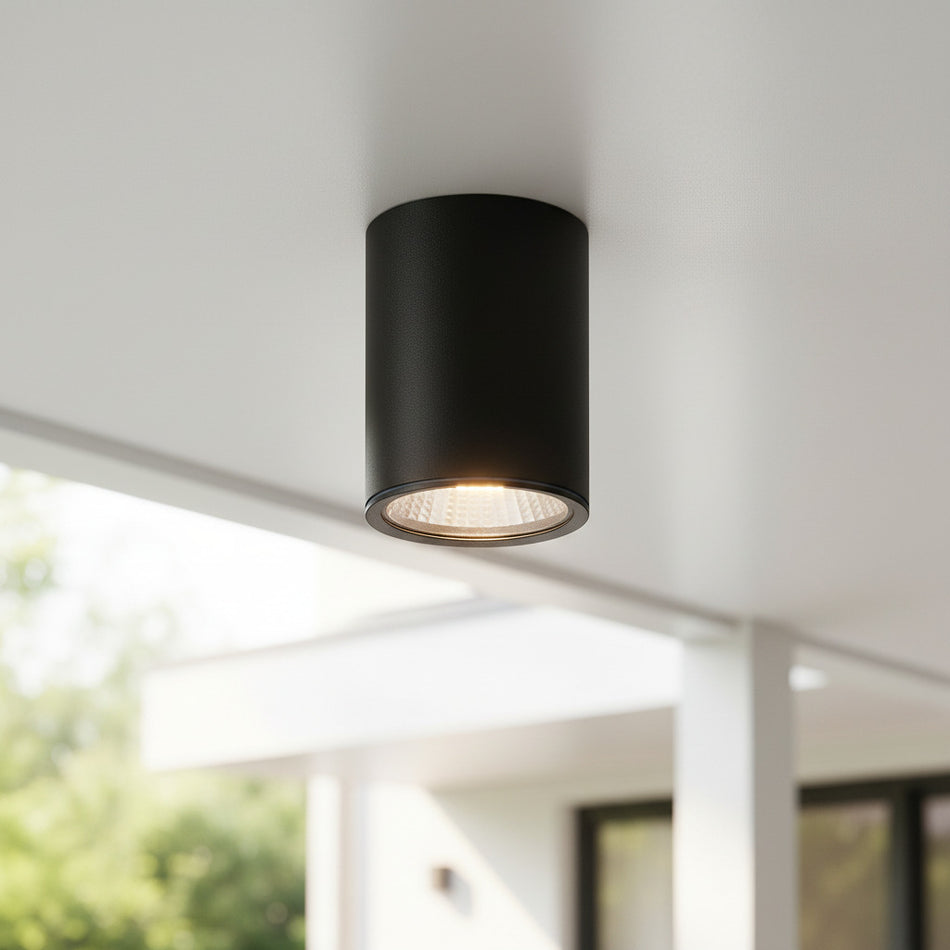 black outdoor surface mounted downlight fitted on an outdoor ceiling 