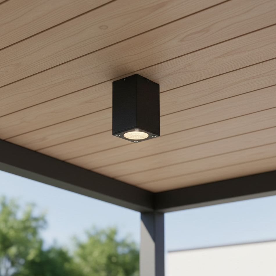 black surface mount exterior soffit light mounted on a wooden outdoor ceiling 