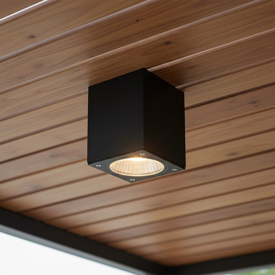 black outdoor soffit downlight mounted on a wooden exterior ceiling 