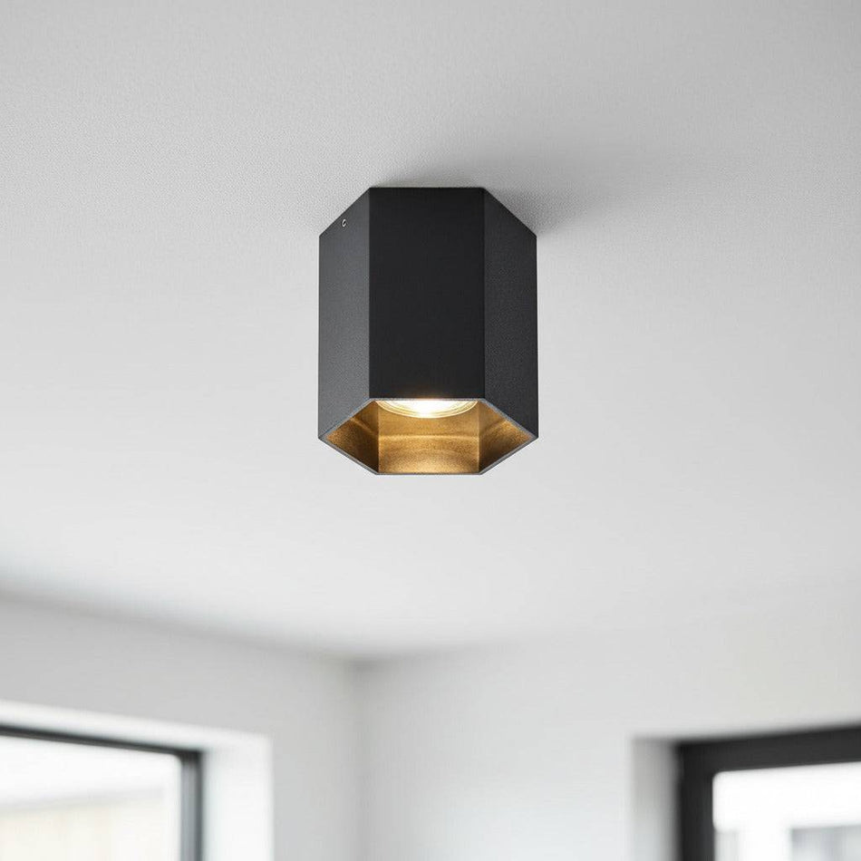 black flush ceiling lamp fixture mounted on a white celing in a modern home