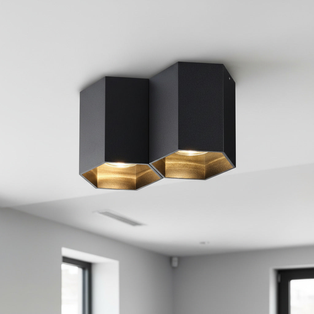 black surface ceiling spotlight mounted on a white ceiling in a home