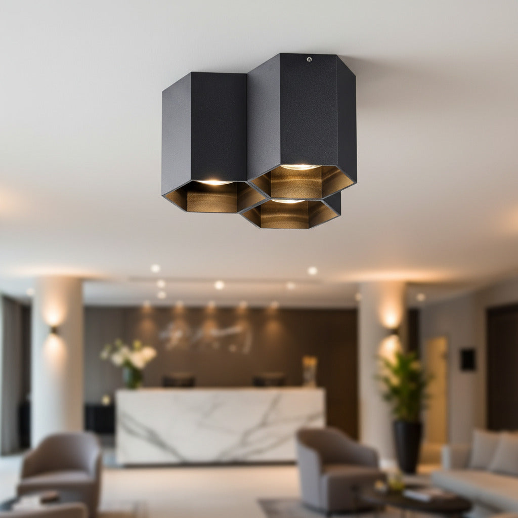 black surface mounted ceiling spotlight mounted in a hotel reception area