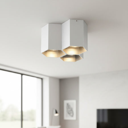 silver ceiling mount light fixture mounted on a white ceiling in a modern home