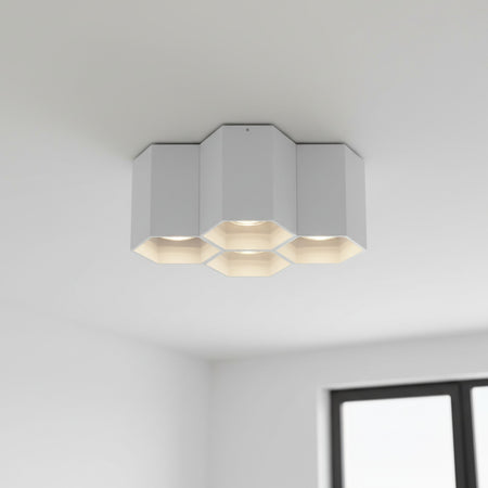 White surface ceiling light mounted on a white ceiling in a modern house