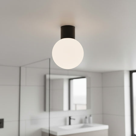 black globe bathroom ceiling light mounted in a modern bathroom 