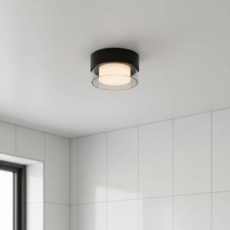 black round LED bathroom ceiling light mounted on the ceiling of a modern bathroom