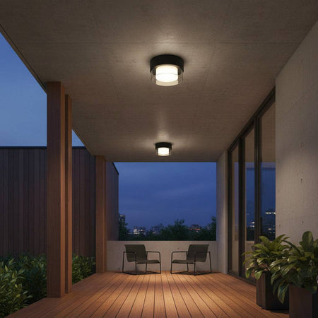 black outdoor ceiling light fixture mounted over an outdoor decking area
