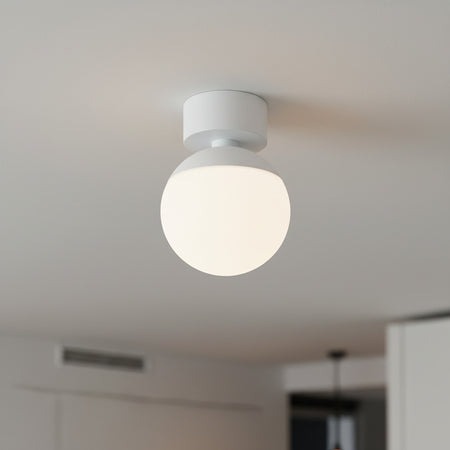 white globe ceiling light fixture mounted on the ceiling of a modern home