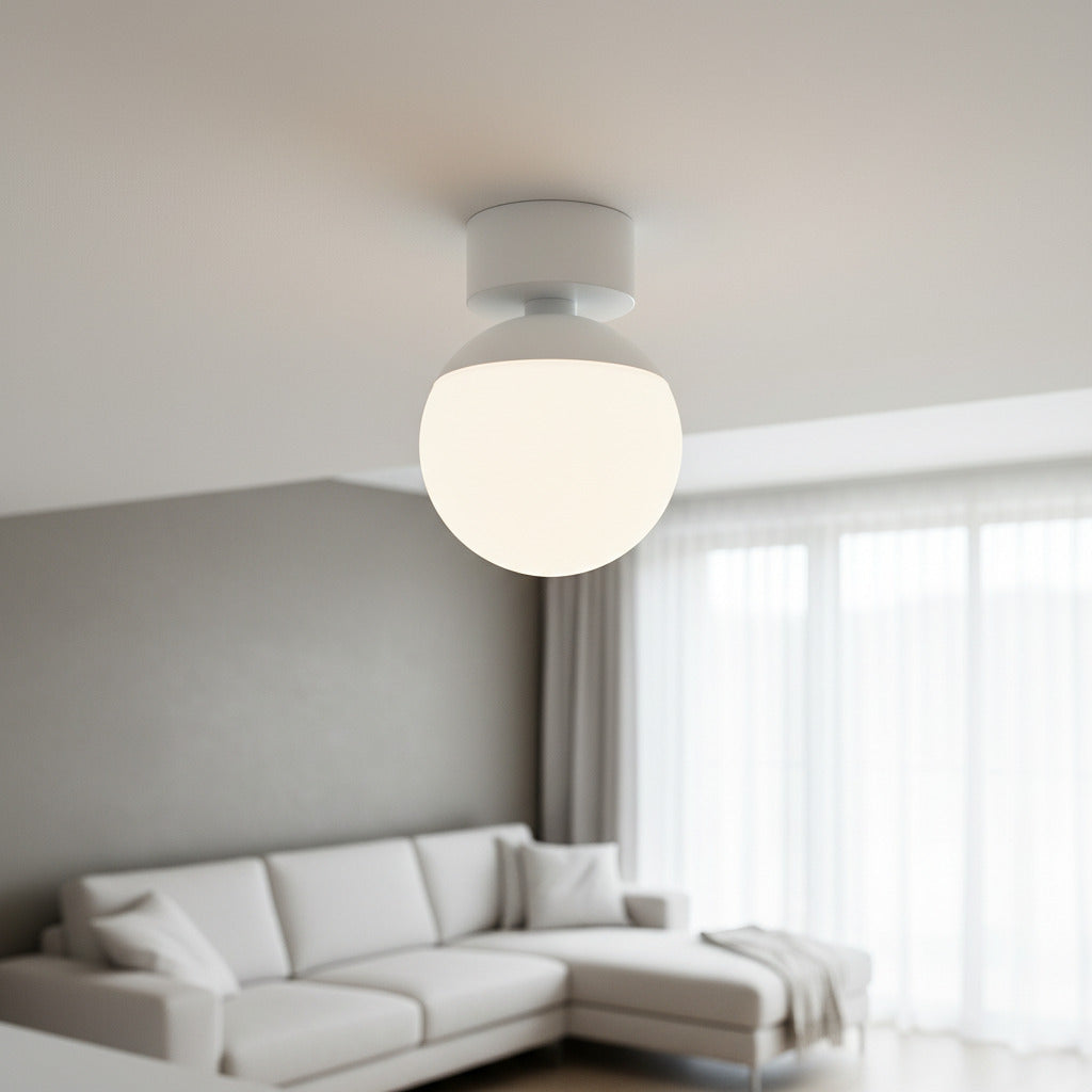 white globe ceiling light fixture mounted on the ceiling in a living room