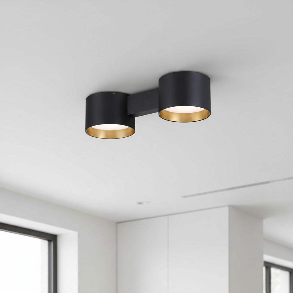 black flush fitting ceiling light installed on a white ceiling in a modern house