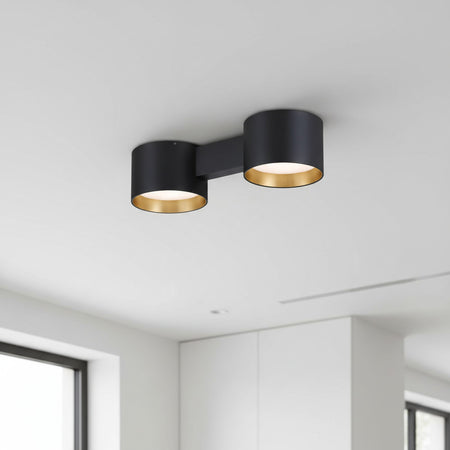 black flush fitting ceiling light installed on a white ceiling in a modern house