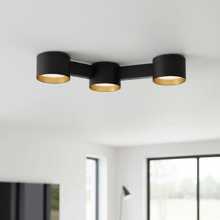 black LED surface downlight mounted on the ceiling in a modern home 
