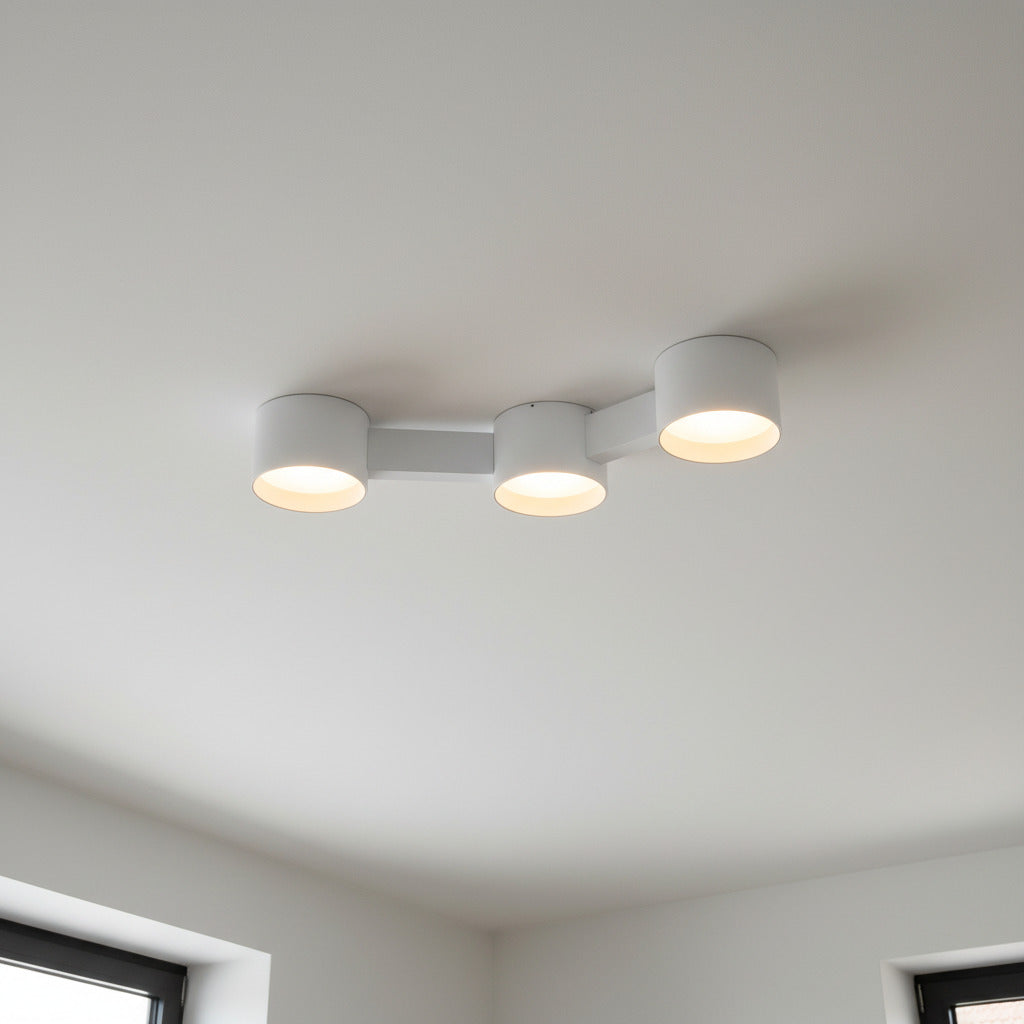 white ceiling downlighter mounted on a white ceiling in a modern home