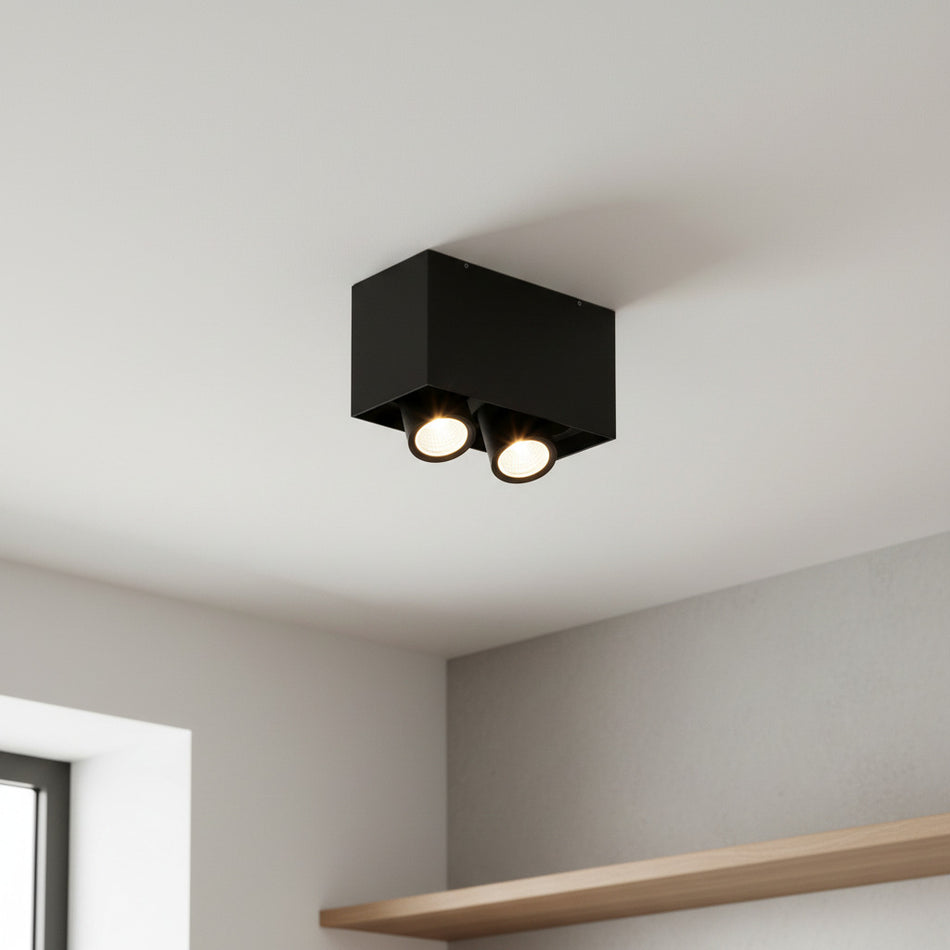 black adjustable LED surface downlight mounted on the ceiling in a modern house