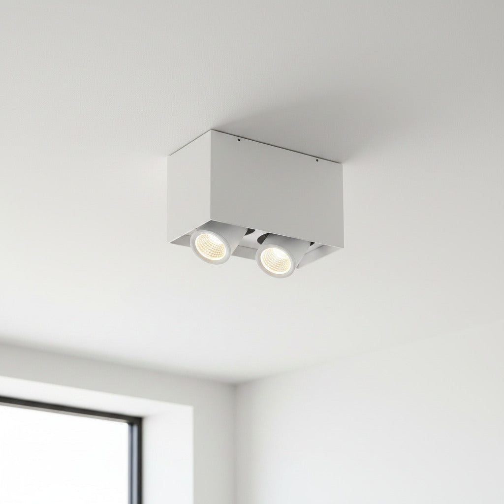 white adjustable LED ceiling light fixture mounted on a white ceiling in a modern house