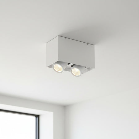 white adjustable LED ceiling light fixture mounted on a white ceiling in a modern house