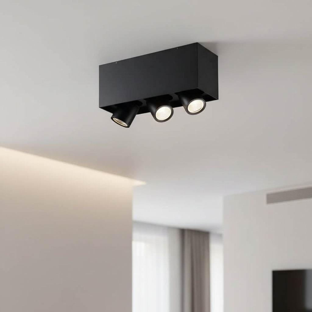 black surface mounted adjustable spotlight installed in a modern hotel room