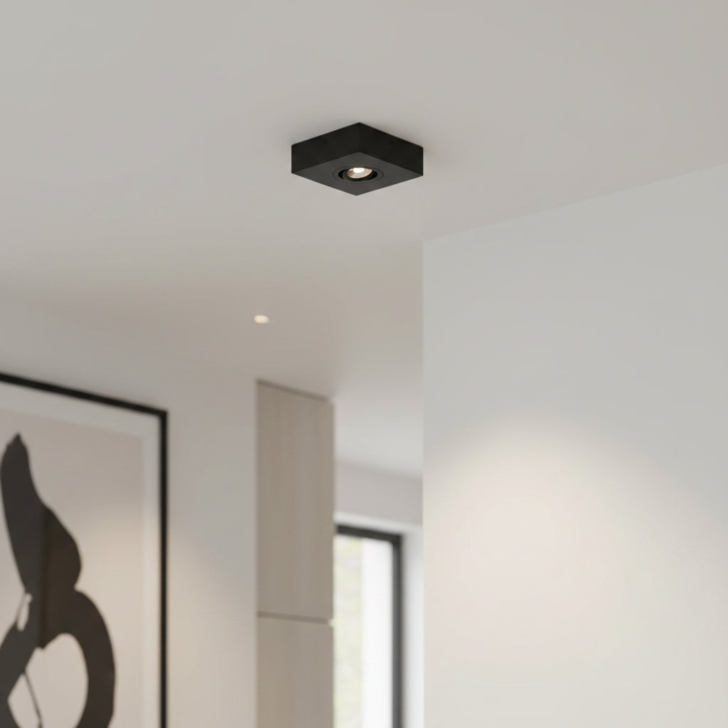 black slimline surface ceiling downlight mounted on the ceiling in a modern home