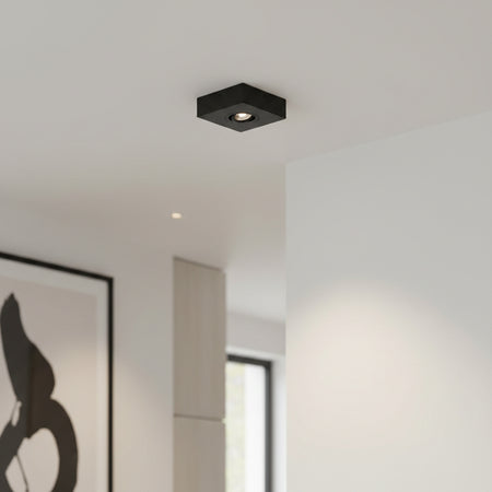 black slimline surface ceiling downlight mounted on the ceiling in a modern home