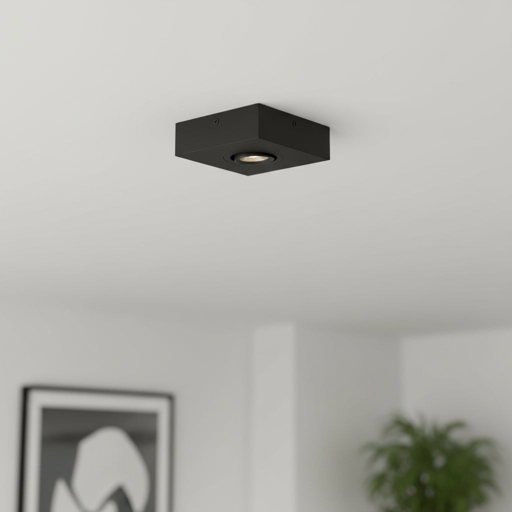 black slimline surface ceiling downlight mounted on the ceiling in a modern house
