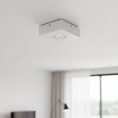 white low profile surface mount downlight installed on a white ceiling
