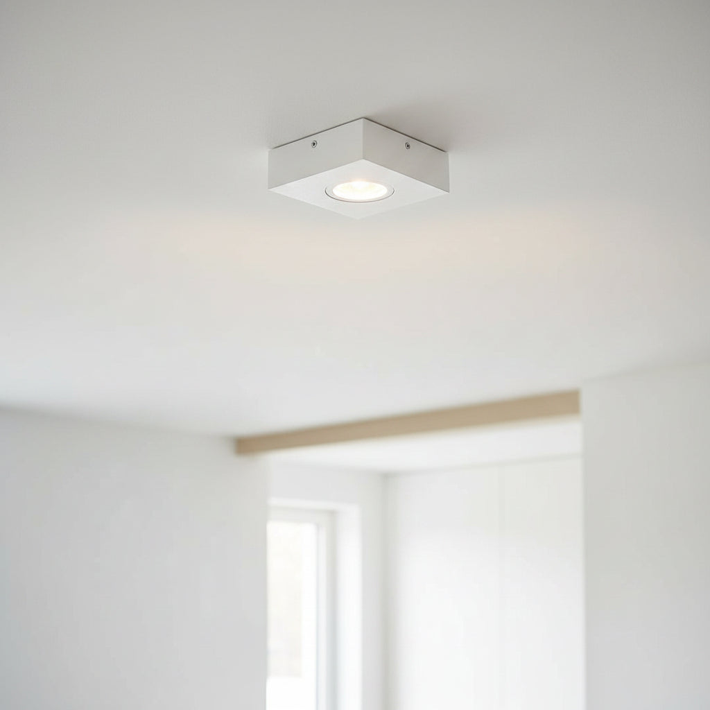 white low profile surface mount downlight installed on the ceiling in a modern home