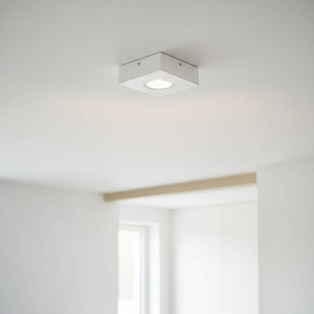 white low profile surface mount downlight installed on the ceiling in a modern home