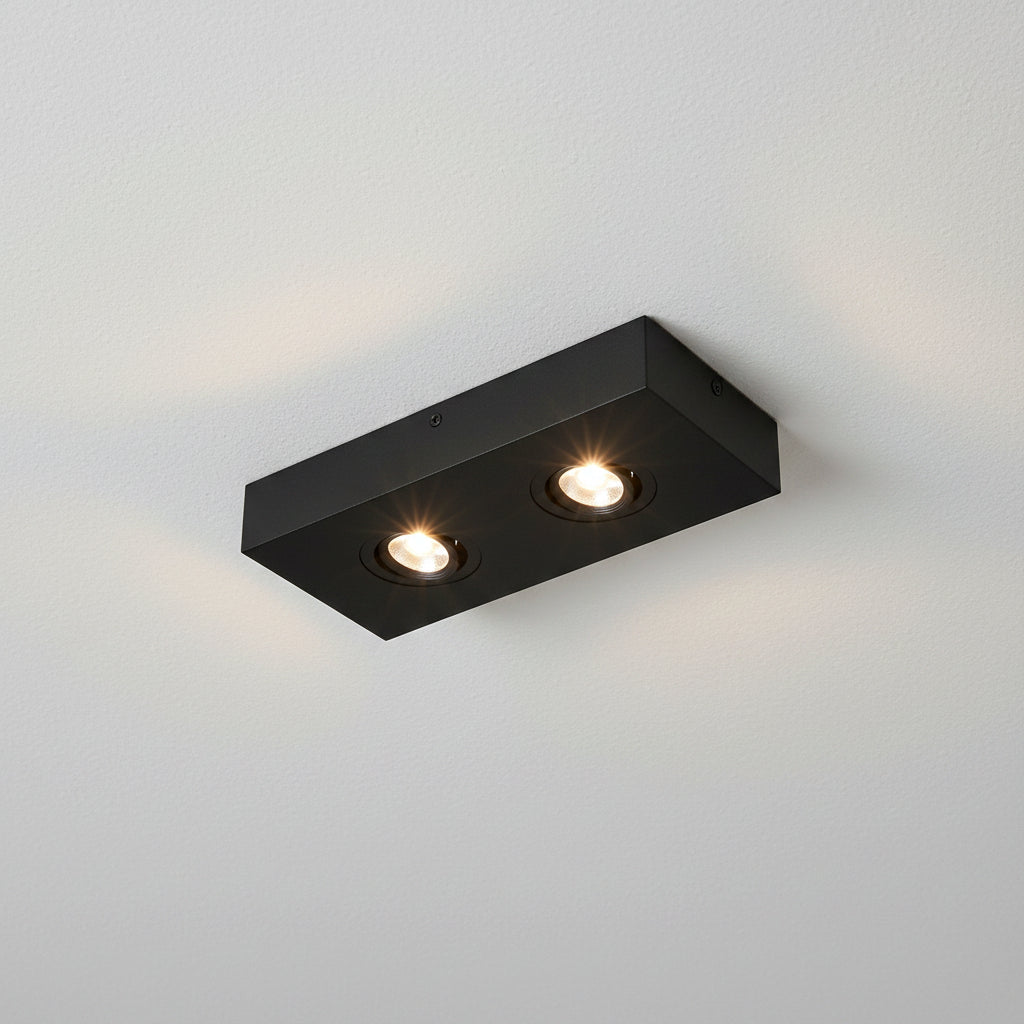 black slim surface mount LED downlight installed on a white ceiling 