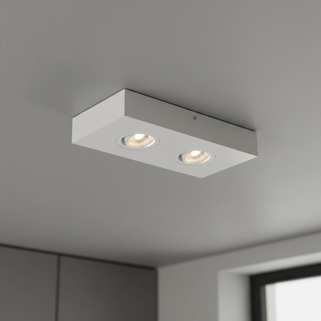 white adjustable LED surface downlight installed on a grey ceiling 