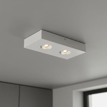 white adjustable LED surface downlight installed on a grey ceiling 