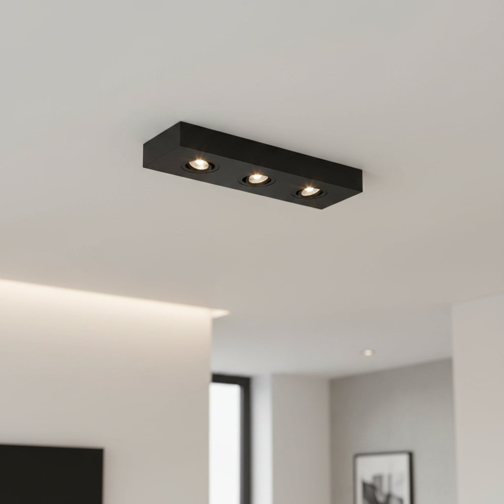black surface mount downlight installed on the ceiling in a modern home 