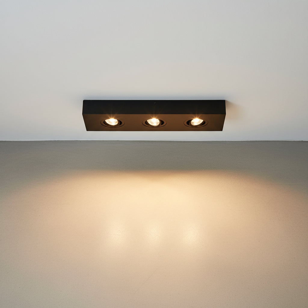 black surface mounted downlight installed on a white ceiling