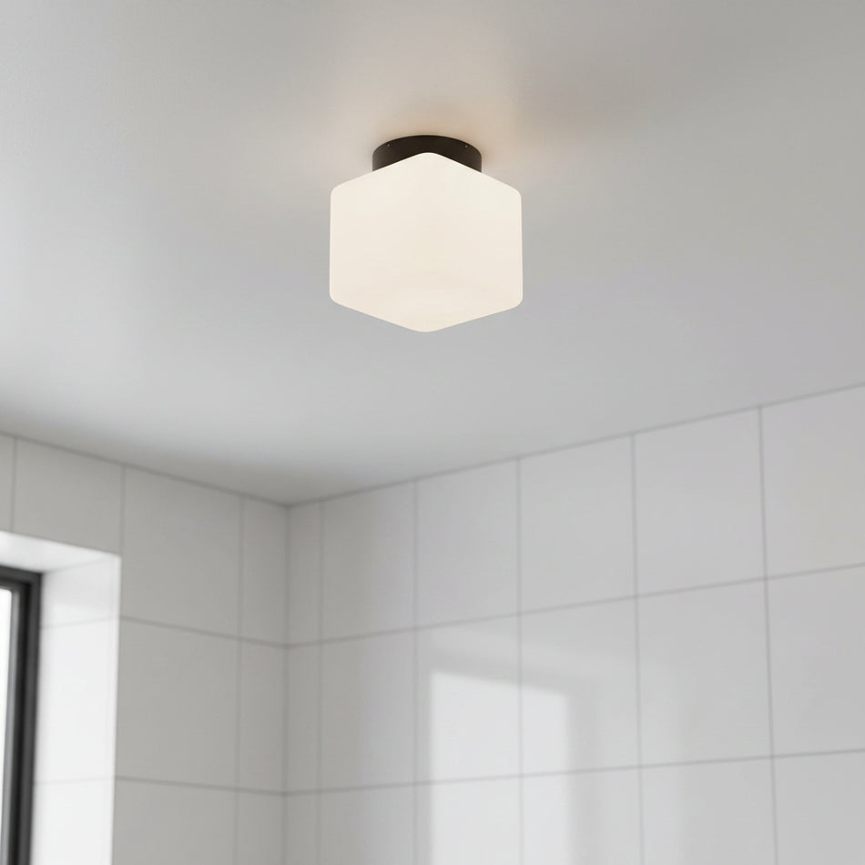 IP65 bathroom ceiling light mounted on a grey ceiling in a bathroom 