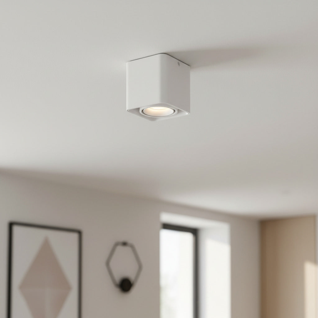 white semi flush ceiling light mounted on a white ceiling in a living room
