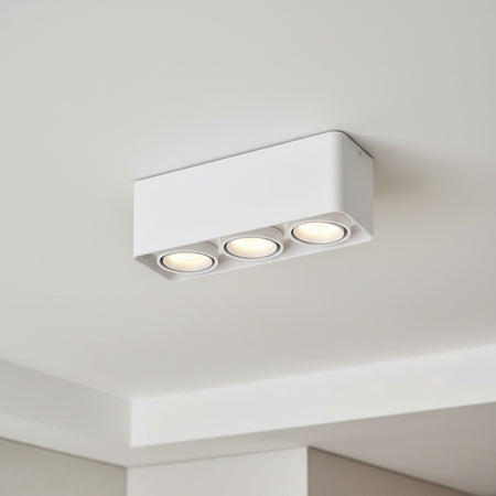 white surface mount spotlights mounted on the ceiling of a hotel room