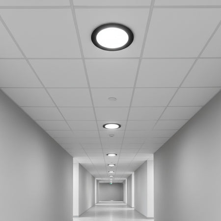 black low profile downlight installed into the ceiling of an office hallway