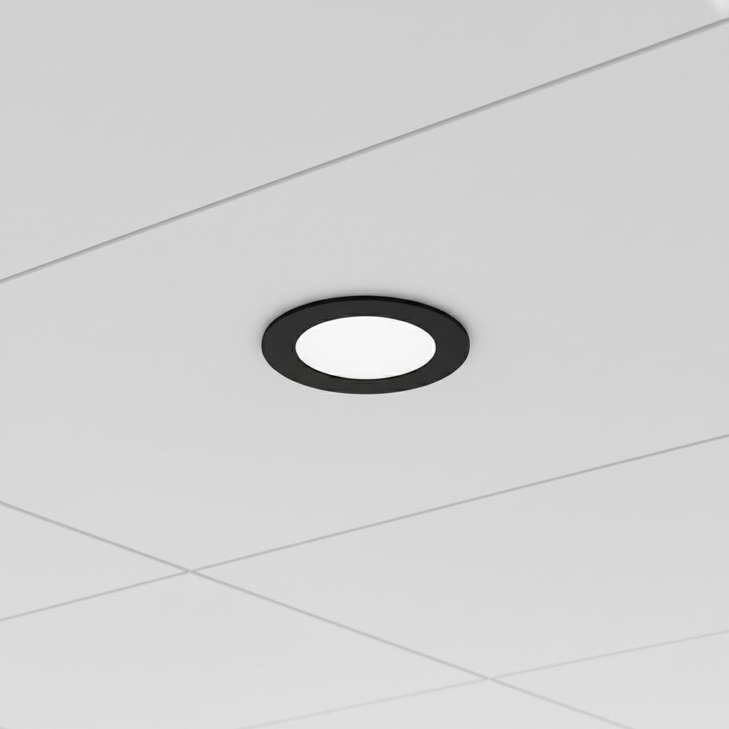 black slimline LED downlight installed in an office suspended ceiling 
