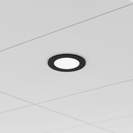 black slimline LED downlight installed in an office suspended ceiling 