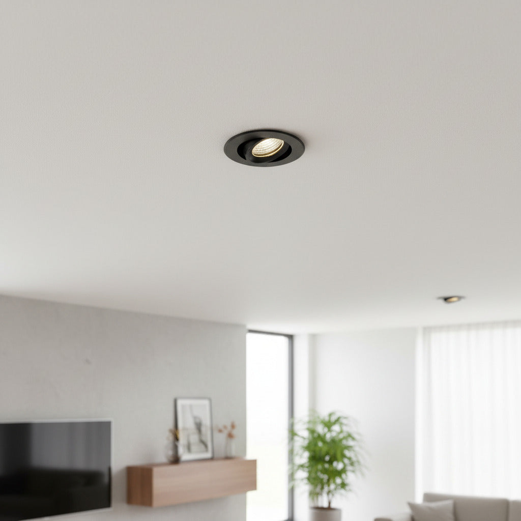 black IP65 LED downlight fitting mounted in the ceiling of a living room
