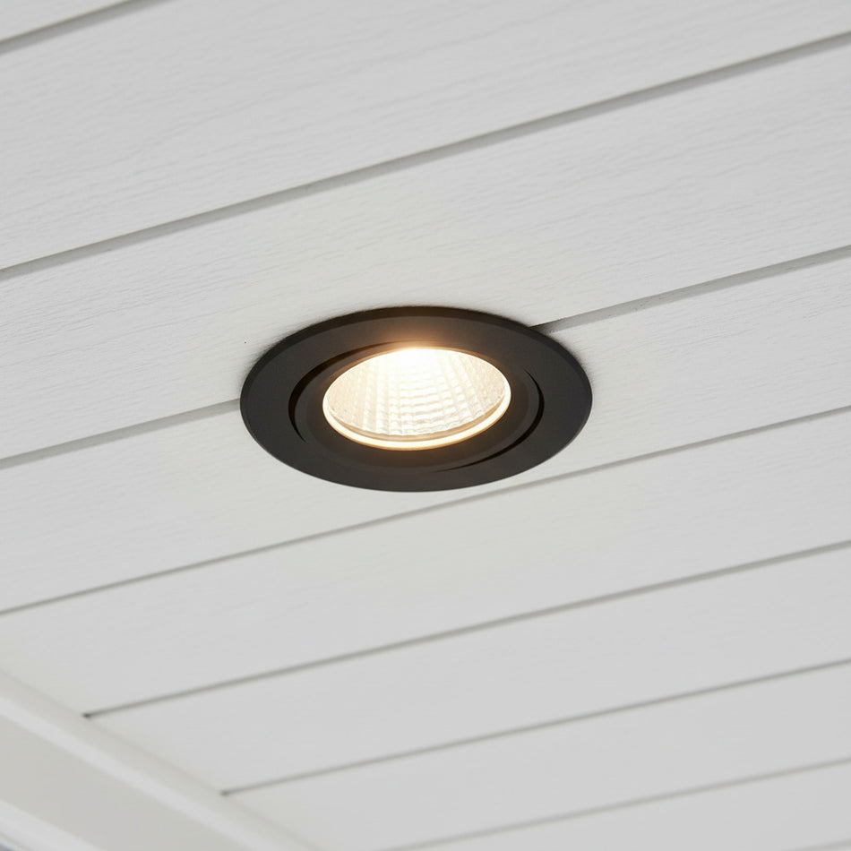 black outside downlight mounted into a white soffit of a home