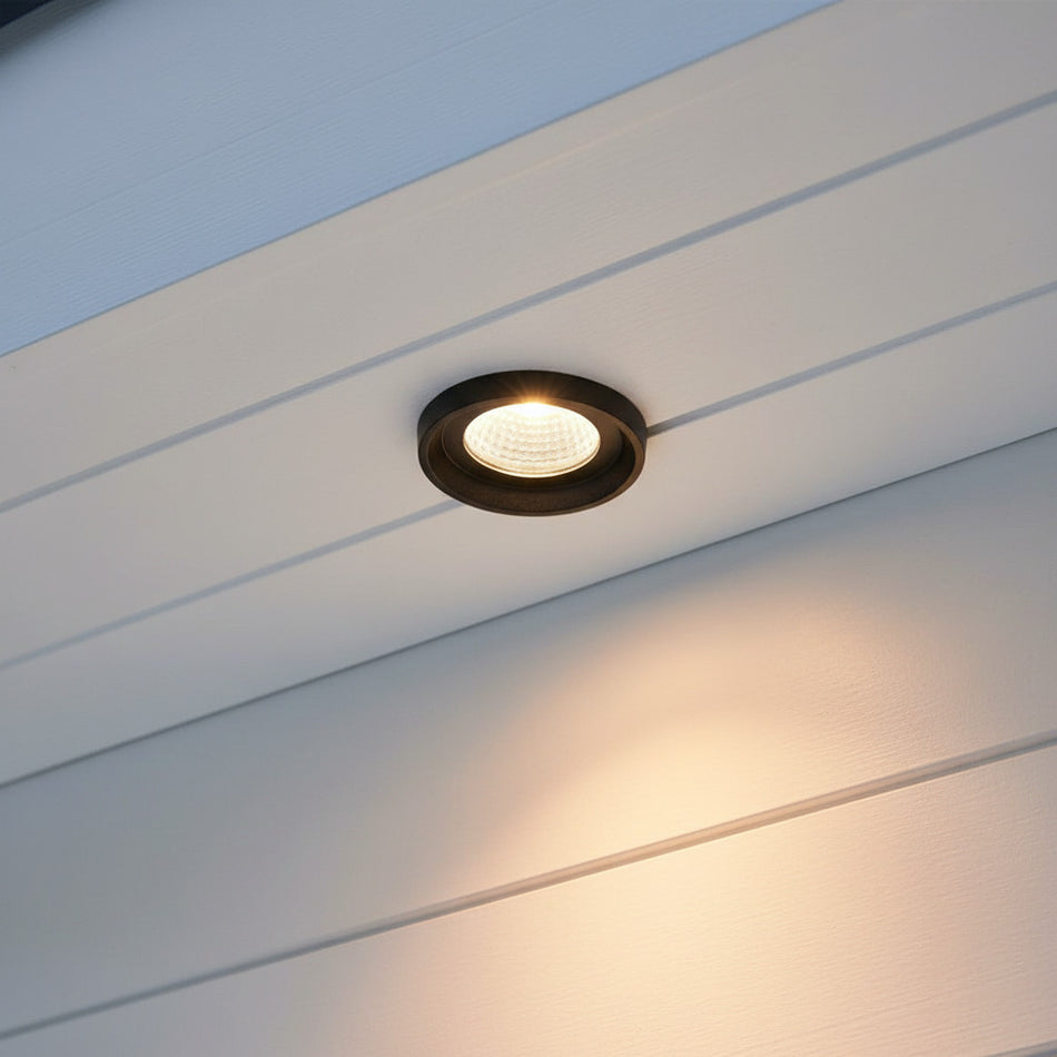 black outdoor downlight mounted under a white house soffit